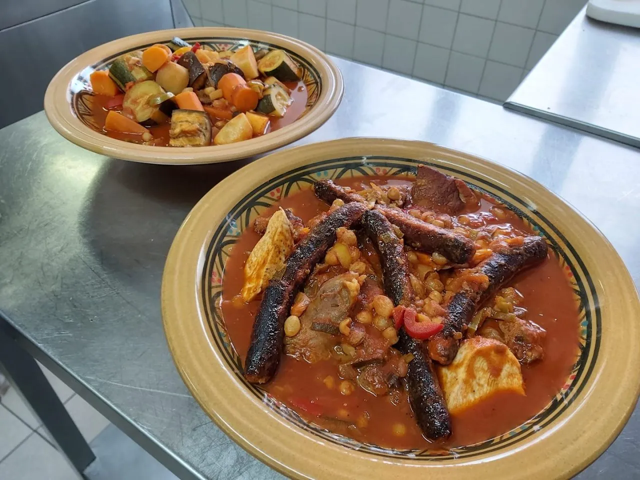 Deux plats mijotés colorés servis dans des assiettes en terre cuite